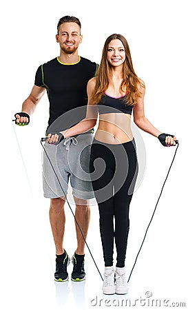 Happy athletic couple - man and woman with with ropes on the whi Stock Photo