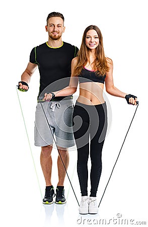 Happy athletic couple - man and woman with ropes on the white Stock Photo