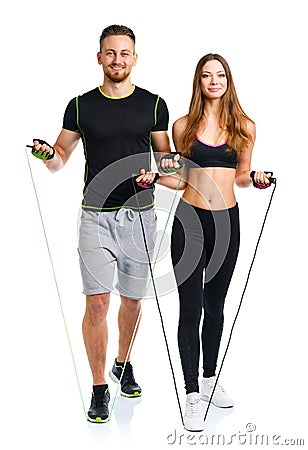 Happy athletic couple - man and woman with ropes on the white Stock Photo