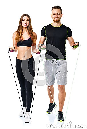 Happy athletic couple - man and woman with ropes on the white Stock Photo