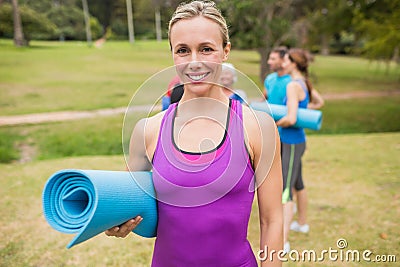 Happy athletic group holding mat Stock Photo