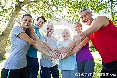 Happy athletic group putting their hands together Stock Photo