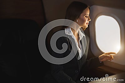 Attractive woman in private jet Stock Photo