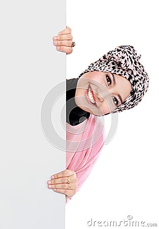 Happy attractive muslim woman holding blank white board Stock Photo