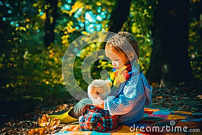 Happy autumn sunny day. Inseparable with toy. Boy cute child play with teddy bear forest background. Child took favorite Stock Photo