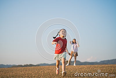 Happy baby asian girl smiling. little girl running and smiling at sunset happy baby girl smiling. little baby running at sunset. Stock Photo