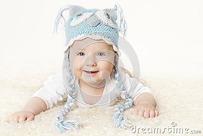 Happy Baby in Blue Knitted Hat, Smiling Kid Boy Raising Head Stock Photo