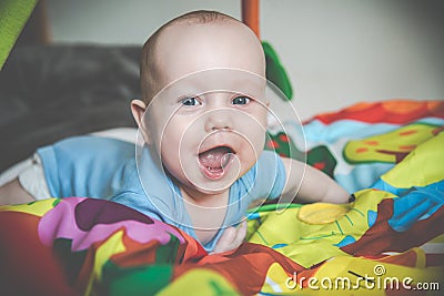 Happy baby boy lying screaming Stock Photo