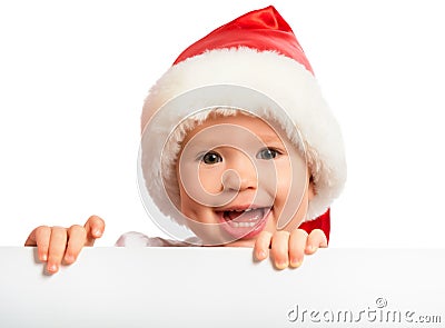 Happy baby in a Christmas hat and a blank billboard isolated on Stock Photo