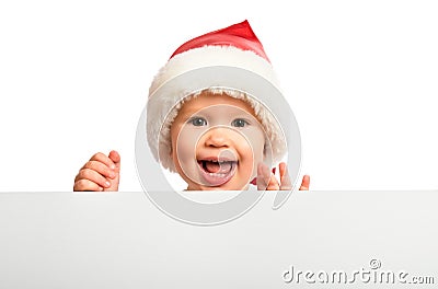 Happy baby in a Christmas hat and a blank billboard isolated on Stock Photo