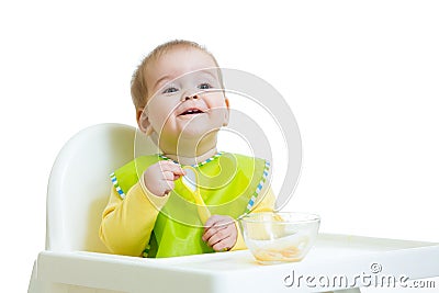 Happy baby kid waiting for food with spoon Stock Photo