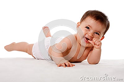 Happy baby laying with thumb in mouth Stock Photo