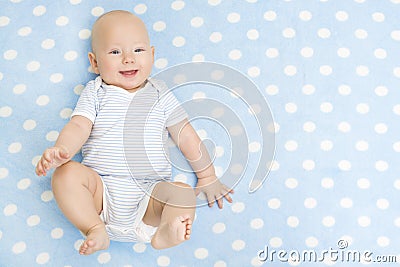 Happy Baby lying on Blue Carpet Background, Smiling Infant Kid Stock Photo