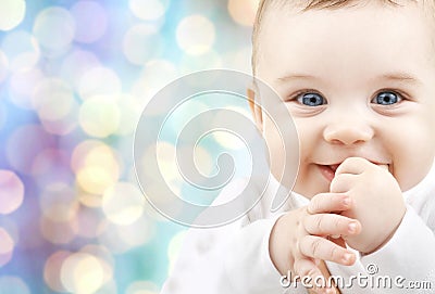 Happy baby over blue holidays lights background Stock Photo