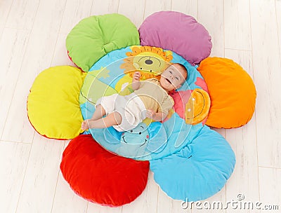 Happy baby on playmat Stock Photo