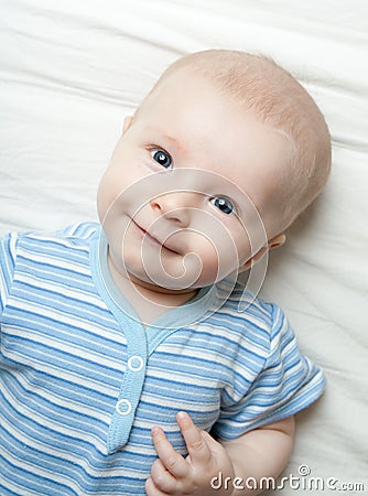 Happy baby on the sheet Stock Photo