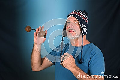 happy bald man with white beard Peruvian cap on his head playing musical instrument asalato looking forward with good expression Stock Photo