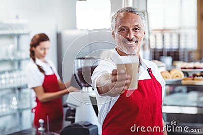 Happy barista giving take-away cup Stock Photo