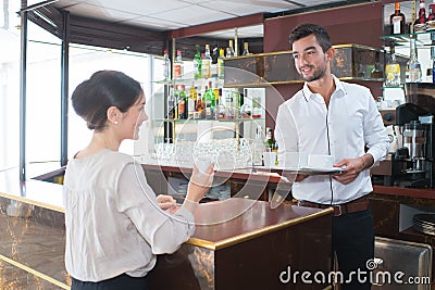 happy barman serving female customer Stock Photo