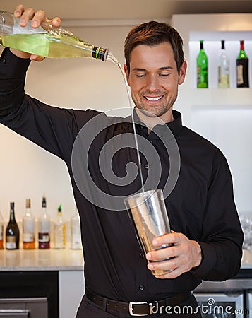 Happy bartender preparing a cocktail Stock Photo