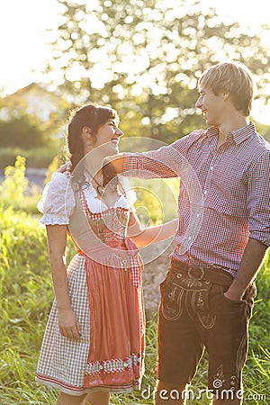 Happy bavarian couple in the evening sun Stock Photo