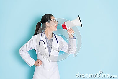 Happy beautiful female doctor using loudspeaker Stock Photo