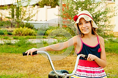 Happy beautiful girl with bicycle on sunset Stock Photo