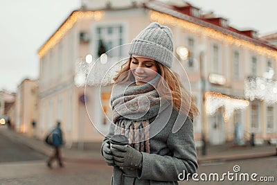 Happy beautiful girl in a fashion vintage coat with a knitted Stock Photo