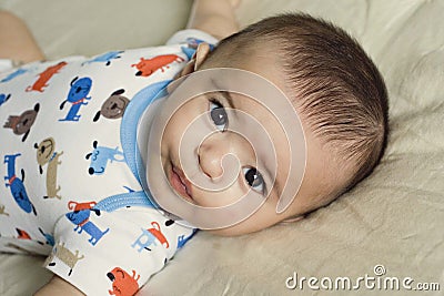 Happy beautiful hispanic baby boy relaxing. Stock Photo