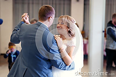 Happy beautiful newlyweds dance in restaurant Stock Photo