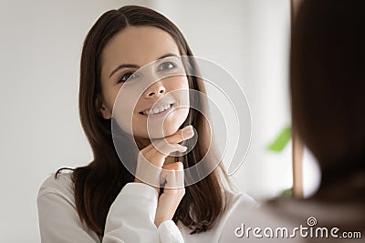 Happy beautiful teen girl looking in mirror, admiring reflection Stock Photo