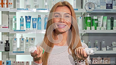 Happy beautiful woman smiling to the camera, shopping at pharmacy Stock Photo