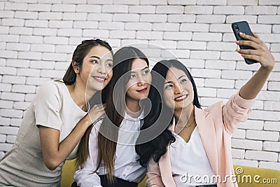 Happy beautiful young asian woman friendship selfie together , Happiness teenagers taking pictures selfie in living room Stock Photo