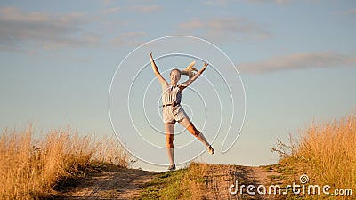 Happy beautiful young girl dancing in a field Stock Photo