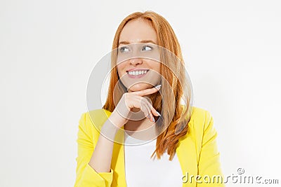 Happy beautiful young red head woman in a stylish yellow jacket copy space. Attractive red hair girl looking away Stock Photo