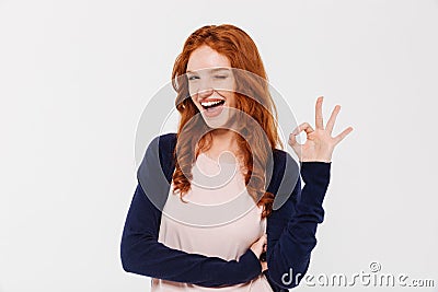 Happy beautiful young redhead lady showing okay gesture. Stock Photo