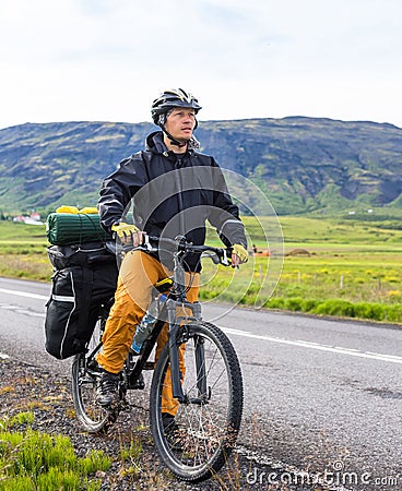 Happy biker on backdrop of mountains in Iceland Stock Photo