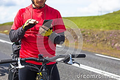 Happy biker using his phone on road in Iceland Stock Photo