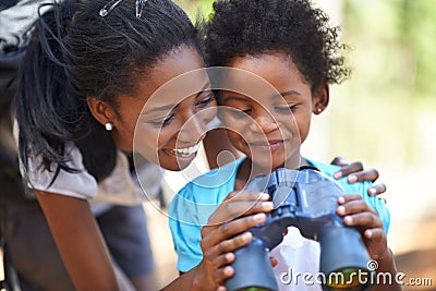 Happy, binocular or black family hiking in forest to relax or bond on holiday vacation together in nature. Child Stock Photo
