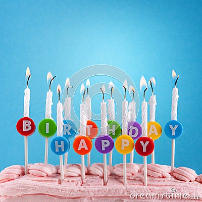 Happy birthday candles on blue background Stock Photo