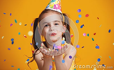 Happy birthday child girl with confetti on yellow background Stock Photo