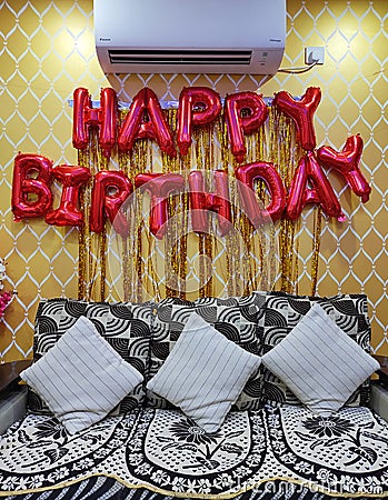 Happy Birthday Golden Balloon Hanging Banner on Wall Stock Photo