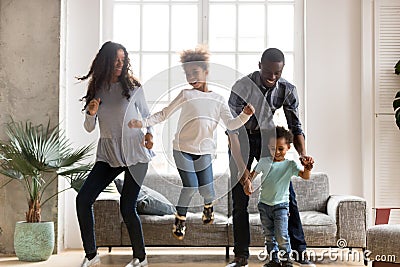 Happy black African family dancing at home Stock Photo
