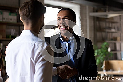 Happy black ceo handshaking rewarding successful worker, employe Stock Photo