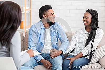 Happy black couple after successful marital therapy with psychologist Stock Photo