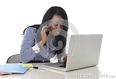 Happy black ethnicity woman working at computer laptop and mobile phone relaxed Stock Photo