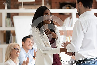 Happy proud black female employee get rewarded handshake caucasian boss Stock Photo