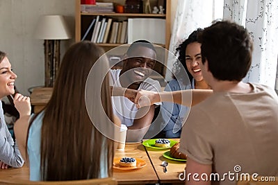 Happy black guy bumping fists with buddy. Stock Photo