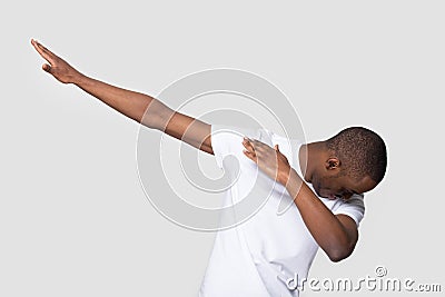 Happy black man making dab gesture on blank studio background Stock Photo