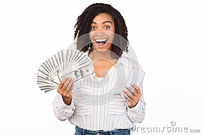 Happy black woman holding money and iPhone 11 pro max Editorial Stock Photo